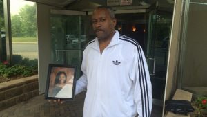 Alvaro Jorge, father of 19-year-old Alize Jorge who was killed in a car crash Sunday night, seen holding his daughter's portrait in front of his 700 Victory Blvd. apartment building. Staten Island Advance/Shane DiMaio