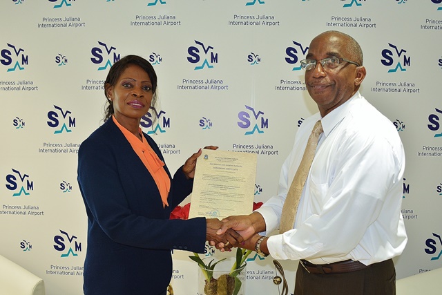 TEATT Minister Irania Arrindell presenting the Aerodrome Certificate to Deputy Managing Director of PJIA Larry Donker (right). (SXM photo)